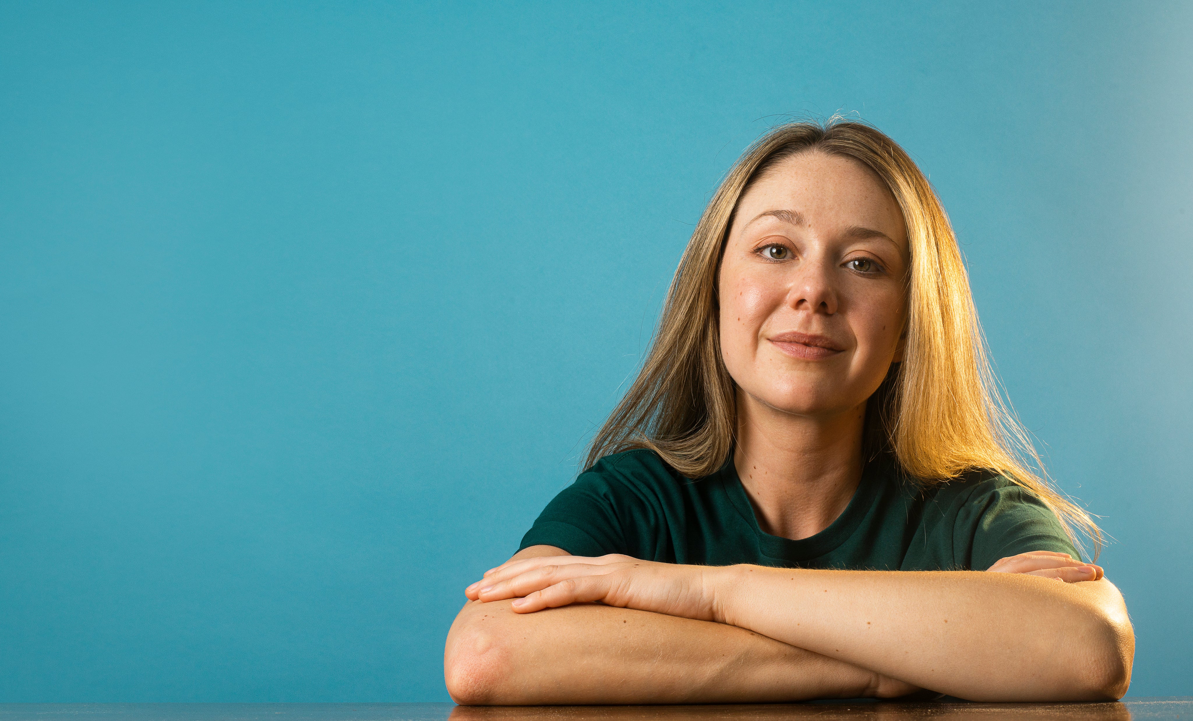 files/portrait-of-a-woman-with-long-brown-hair-and-crossed-arms.jpg